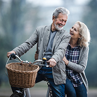 Mature couple riding bicycle