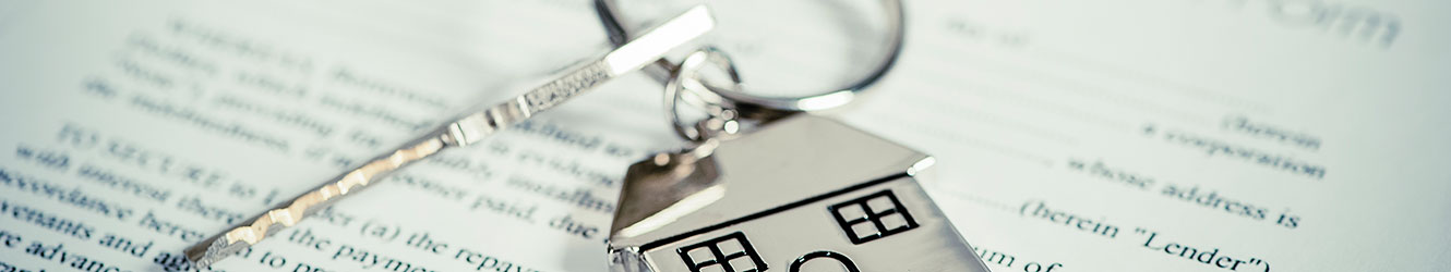 Keys on top of mortgage papers