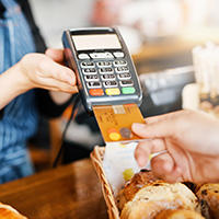 Close up of person paying with credit card