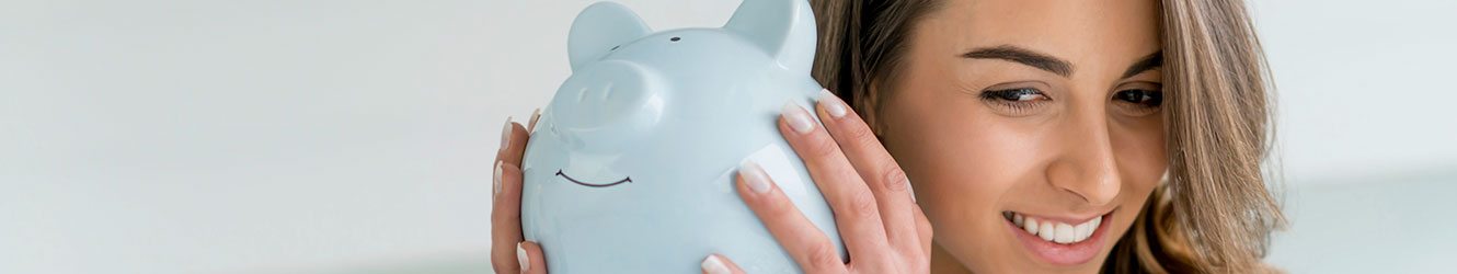 Woman shaking piggy bank