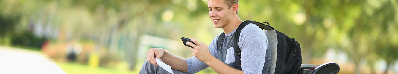College student depositing check with phone